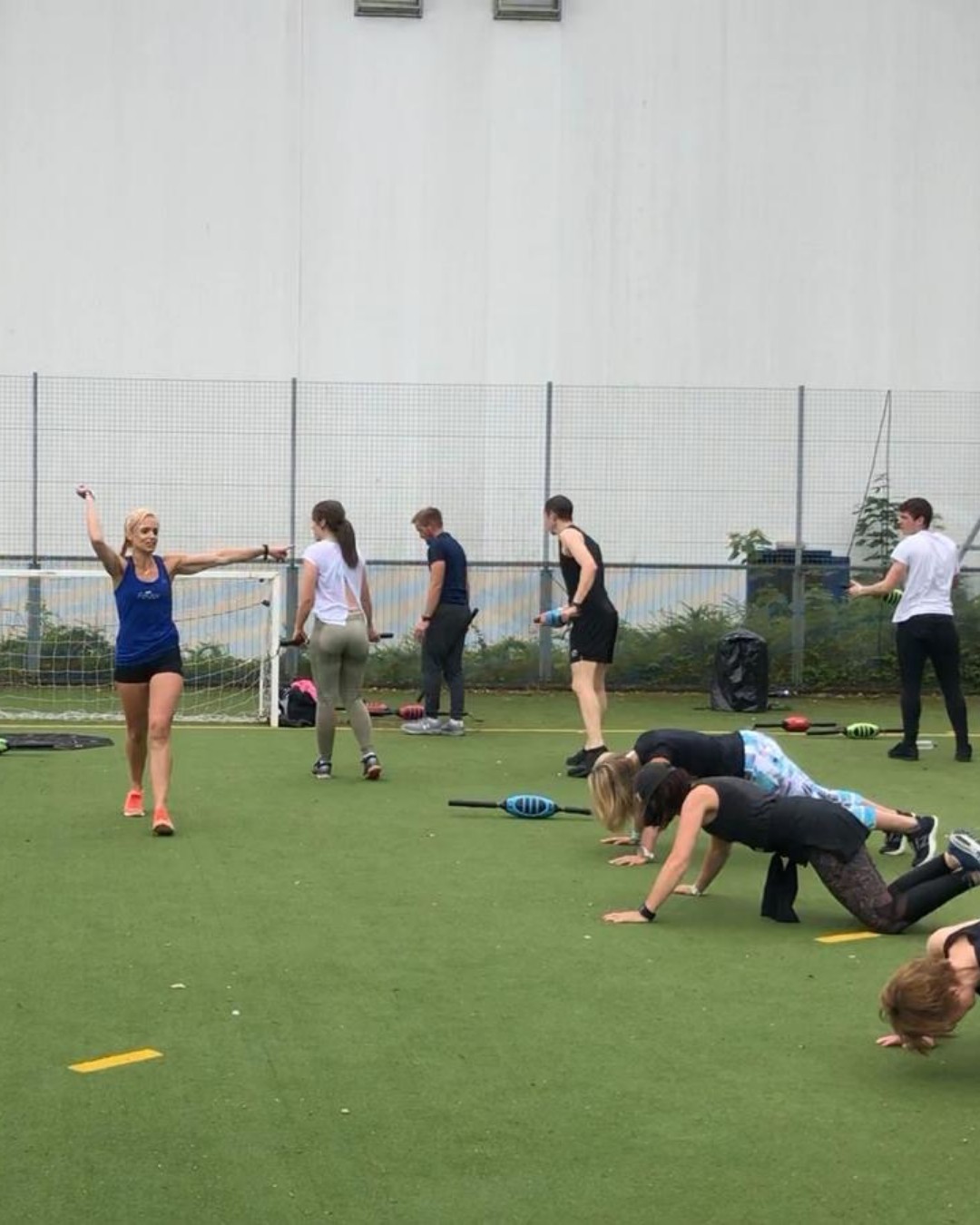 A group on the astro, one woman with her arms wide, others crawling